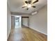Bright bedroom with wood-look floors and view of kitchen at 424 E Welch Rd, Apopka, FL 32712