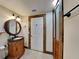 Elegant bathroom with dark vanity, tile floors, and a shower at 424 E Welch Rd, Apopka, FL 32712