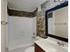 Clean bathroom with stone-look tile and updated fixtures at 424 E Welch Rd, Apopka, FL 32712