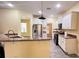 Open kitchen boasts granite counters & stainless steel appliances at 3060 Rambler Ave, Saint Cloud, FL 34772