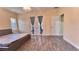 Main bedroom with wood-look tile floors and backyard access at 3060 Rambler Ave, Saint Cloud, FL 34772