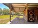 Covered area outside barn stalls with brick flooring at 3060 Rambler Ave, Saint Cloud, FL 34772
