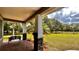 Covered porch with stone pillars and tranquil views at 3060 Rambler Ave, Saint Cloud, FL 34772