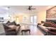 Open living room with hardwood floors and access to backyard at 3060 Rambler Ave, Saint Cloud, FL 34772