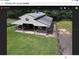 Gray metal barn with stalls and outdoor arena at 3060 Rambler Ave, Saint Cloud, FL 34772