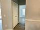 White-door hallway with wood-look floors leading to another room at 3561 Conroy Rd # 227, Orlando, FL 32839
