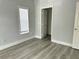 Bright bedroom with wood-look floors, window blinds, and a spacious closet at 3561 Conroy Rd # 227, Orlando, FL 32839