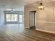 Spacious living area with wood-look flooring and access to balcony at 3561 Conroy Rd # 227, Orlando, FL 32839