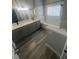 Double vanity bathroom with gray cabinets and a garden tub at 3561 Conroy Rd # 227, Orlando, FL 32839