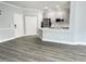 Open concept living and kitchen area with gray flooring at 3561 Conroy Rd # 227, Orlando, FL 32839