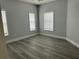Bright bedroom with vinyl flooring and three windows at 3561 Conroy Rd # 227, Orlando, FL 32839