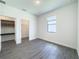 Bright bedroom with gray floors, spacious closets, and built-in shelving at 3229 Energy Dr, Kissimmee, FL 34747