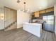 Modern kitchen with island, stainless steel appliances, and wood cabinets at 3229 Energy Dr, Kissimmee, FL 34747