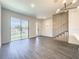 Open living room with sliding doors and modern stairs at 3229 Energy Dr, Kissimmee, FL 34747