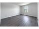Simple bedroom with wood-look floors and a window at 3229 Energy Dr, Kissimmee, FL 34747