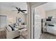 Living room with beige couch and view into bedroom with bunk beds at 8100 Princess Palm Ln # 201, Kissimmee, FL 34747