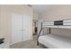 Bunk bed and twin bed in a well-lit bedroom with double doors leading to a closet at 8100 Princess Palm Ln # 201, Kissimmee, FL 34747