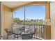 Private balcony with a table and chairs, overlooking a community view at 8100 Princess Palm Ln # 201, Kissimmee, FL 34747