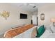 Main bedroom with king bed, en-suite bathroom access, and a large TV at 8100 Princess Palm Ln # 201, Kissimmee, FL 34747