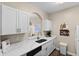 White cabinets, quartz countertops, and stainless steel sink at 8100 Princess Palm Ln # 201, Kissimmee, FL 34747