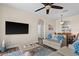 Living room with comfortable sofas, a large TV, and a view into the dining area at 8100 Princess Palm Ln # 201, Kissimmee, FL 34747