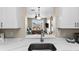 Kitchen sink with a view into the living room and balcony at 8100 Princess Palm Ln # 201, Kissimmee, FL 34747