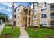 Building exterior with landscaping and walkway at 8100 Princess Palm Ln # 201, Kissimmee, FL 34747