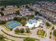 Aerial view of community with pool, tennis courts, and ample parking at 8100 Princess Palm Ln # 201, Kissimmee, FL 34747