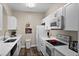 Modern white kitchen with stainless steel appliances at 8100 Princess Palm Ln # 201, Kissimmee, FL 34747