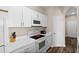 Modern white kitchen with stainless steel appliances at 8100 Princess Palm Ln # 201, Kissimmee, FL 34747