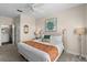 Spacious main bedroom with king-size bed and access to the en-suite bathroom at 8100 Princess Palm Ln # 201, Kissimmee, FL 34747