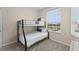 Bedroom with a bunk bed, large window, and neutral decor at 8100 Princess Palm Ln # 201, Kissimmee, FL 34747