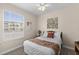 Bedroom with a queen bed, ceiling fan, and large window at 8100 Princess Palm Ln # 201, Kissimmee, FL 34747