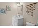 Updated bathroom with a white vanity and stylish wall decor at 8100 Princess Palm Ln # 201, Kissimmee, FL 34747