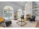 Elegant living room with high ceilings, fireplace, and access to the pool area at 2234 Via Luna, Winter Park, FL 32789