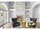 Living room with fireplace, built-in shelving, and comfortable armchairs at 2234 Via Luna, Winter Park, FL 32789