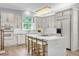 Updated kitchen boasting white cabinets, large island, and breakfast bar at 2234 Via Luna, Winter Park, FL 32789
