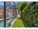 Screened-in pool area with artificial turf and privacy hedges at 2234 Via Luna, Winter Park, FL 32789