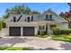 Two-car garage with gray doors and a brick driveway at 2234 Via Luna, Winter Park, FL 32789