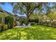 Landscaped backyard with fire pit, seating, and lush green lawn at 2234 Via Luna, Winter Park, FL 32789