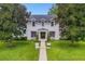 Two story house with white brick exterior, manicured lawn, and walkway at 2234 Via Luna, Winter Park, FL 32789