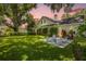 Expansive backyard with fire pit and seating area under lush trees at 2234 Via Luna, Winter Park, FL 32789