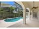 Inviting pool area with covered patio and lush landscaping at 2234 Via Luna, Winter Park, FL 32789