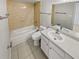 Bathroom features a tub, toilet and vanity at 5545 Devonbriar Way # I101, Orlando, FL 32822