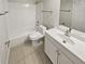 Clean bathroom with a bathtub, toilet and vanity at 5545 Devonbriar Way # I101, Orlando, FL 32822