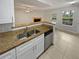 Kitchen features granite countertops and stainless steel appliances at 5545 Devonbriar Way # I101, Orlando, FL 32822