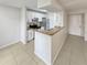 Kitchen features white cabinets, granite countertops and stainless steel appliances at 5545 Devonbriar Way # I101, Orlando, FL 32822