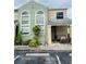 Green house exterior with landscaping and parking at 2444 Summerfield Way # 1, Kissimmee, FL 34741