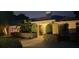 Night view of house entrance with landscaping at 342 Maple Dr, Longwood, FL 32750
