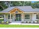 Charming farmhouse front porch with stone pillars and wooden beams at 19906 Eldorado Dr, Eustis, FL 32736